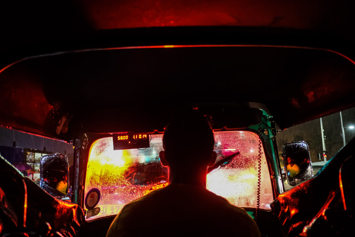 A 3-wheeler ride home on a very rainy evening. The brake lights lit up the entire inside of the 3-wheeler. This was the day of my ebook release, fittingly the 3-wheeler looks like a nightclub! Fujifilm X-Pro2.