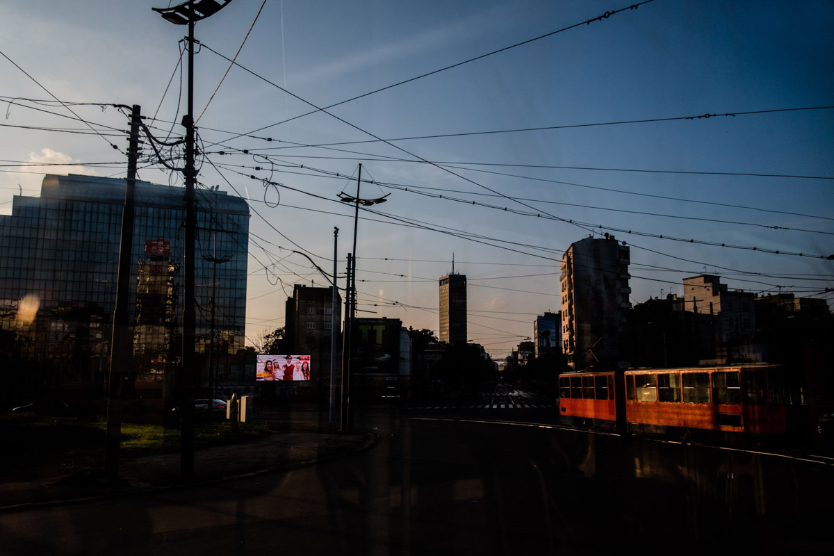 The best shot I have ever done from any moving sort of transport, shot at a big roundabout as the sun was setting and just lighting up another red tram passing by in the opposite direction.